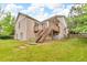 Backyard view showcases the home's brick exterior, wooden deck, and lush green lawn at 5960 S Estes St, Littleton, CO 80123