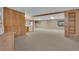 Partially finished basement with carpet and wood paneling offers a versatile space for recreation or storage at 5960 S Estes St, Littleton, CO 80123
