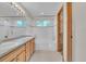 Bright bathroom with double sinks, a large mirror, and a well-maintained shower-tub combination at 5960 S Estes St, Littleton, CO 80123