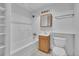 Bright bathroom featuring a tub and shower combination, along with a modern vanity and mirrored cabinet at 5960 S Estes St, Littleton, CO 80123