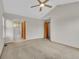 Carpeted bedroom featuring access to the bathroom, offering convenient accessibility and neutral decor at 5960 S Estes St, Littleton, CO 80123