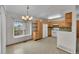A clean kitchen featuring light wood cabinets, white appliances, and an eat-in breakfast area at 5960 S Estes St, Littleton, CO 80123