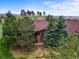 A distant elevated aerial view showing the roof of a home with landscaping and mature trees at 23961 E Easter Pl, Aurora, CO 80016