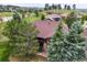 Aerial view of home with a red roof surrounded by mature trees at 23961 E Easter Pl, Aurora, CO 80016