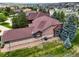 An elevated aerial view of a beautiful home with lush landscaping and mature trees at 23961 E Easter Pl, Aurora, CO 80016