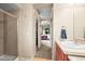 Bathroom featuring walk-in shower and a view to a bedroom at 23961 E Easter Pl, Aurora, CO 80016