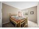 Cozy bedroom with a decorative bed frame, a side table, and a bright window at 23961 E Easter Pl, Aurora, CO 80016