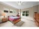 Well-lit bedroom with neutral carpet, ceiling fan, and windows offering green views at 23961 E Easter Pl, Aurora, CO 80016
