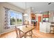 Bright breakfast nook with hardwood floors, a wooden table, and a view of the backyard at 23961 E Easter Pl, Aurora, CO 80016
