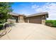 Charming home featuring a three-car garage and a stone and brown siding at 23961 E Easter Pl, Aurora, CO 80016
