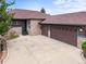 Charming home featuring a three-car garage and a stone and brown siding at 23961 E Easter Pl, Aurora, CO 80016