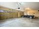 Spacious three-car garage with ample room for parking and storage and a vintage car at 23961 E Easter Pl, Aurora, CO 80016