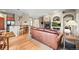 Open-concept living room boasts hardwood floors, a cozy fireplace, and seamless access to the adjacent kitchen at 23961 E Easter Pl, Aurora, CO 80016
