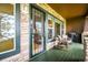Inviting porch area featuring rocking chairs, wood style floors, and stone accents at 23961 E Easter Pl, Aurora, CO 80016