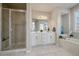 Elegant bathroom with double vanity, soaking tub, and shower at 5199 S Fairplay St, Aurora, CO 80015