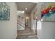 Bright entryway with hardwood floors, staircase, and powder room at 5199 S Fairplay St, Aurora, CO 80015