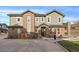 Two-story townhome with brick and siding exterior, a bench, and a small yard at 5199 S Fairplay St, Aurora, CO 80015