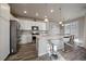 Modern kitchen with white cabinets and a large island at 5199 S Fairplay St, Aurora, CO 80015