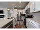 Bright kitchen featuring stainless steel appliances and an island at 5199 S Fairplay St, Aurora, CO 80015