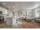 Modern kitchen with white cabinets, island, and stainless steel appliances at 5199 S Fairplay St, Aurora, CO 80015