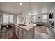 Open concept kitchen and dining area with island and hardwood floors at 5199 S Fairplay St, Aurora, CO 80015