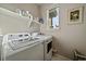 Laundry room with washer, dryer, and overhead shelving at 5199 S Fairplay St, Aurora, CO 80015