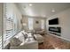 Living room with fireplace, large TV, and comfortable seating at 5199 S Fairplay St, Aurora, CO 80015