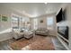 Living room with fireplace, large TV, and comfortable seating at 5199 S Fairplay St, Aurora, CO 80015