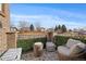 Cozy patio with wicker furniture and artificial greenery, offering a relaxing outdoor space at 5199 S Fairplay St, Aurora, CO 80015