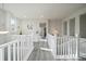 Bright upstairs hallway with white railings and hardwood floors at 5199 S Fairplay St, Aurora, CO 80015