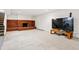 Finished basement with brick fireplace and large TV at 14793 E Hampden Pl, Aurora, CO 80014