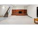 Finished basement boasts a cozy red brick fireplace and adjacent stairway at 14793 E Hampden Pl, Aurora, CO 80014