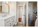 Beautiful bathroom with marble countertop vanity and tiled shower at 14793 E Hampden Pl, Aurora, CO 80014