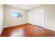 This bedroom has hard wood floors, a large window, and two closets at 14793 E Hampden Pl, Aurora, CO 80014