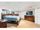 Bedroom with full furnishings including a large bed and TV at 14793 E Hampden Pl, Aurora, CO 80014