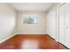 This bedroom has hard wood floors, a large window, and a closet at 14793 E Hampden Pl, Aurora, CO 80014
