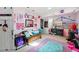 Whimsical bedroom with colorful decorations and ample space for activities at 14793 E Hampden Pl, Aurora, CO 80014