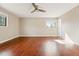 Spacious bedroom with a ceiling fan, hardwood floors, and natural light at 14793 E Hampden Pl, Aurora, CO 80014