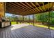 Spacious covered deck with wood flooring and outdoor grill overlooks the backyard at 14793 E Hampden Pl, Aurora, CO 80014