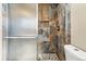 Shower stall with beautiful tiled wall, sliding door, and tiled floor at 14793 E Hampden Pl, Aurora, CO 80014
