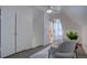 Bright attic space with carpet, sloped ceilings, white walls, and a view of the room through a barn door at 124 Elati St, Denver, CO 80223