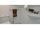 Bright bathroom featuring a toilet, sink, modern faucet, and stylish brown towel at 124 Elati St, Denver, CO 80223