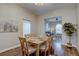 Warm dining room with a wooden table set for a meal and a view to a living room at 124 Elati St, Denver, CO 80223