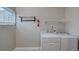 Functional laundry room equipped with a washer, dryer, shelving, and storage options at 124 Elati St, Denver, CO 80223