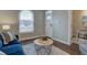 Cozy living room featuring a blue sofa, wood floors, and a stylish coffee table at 124 Elati St, Denver, CO 80223