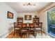 Bright dining room features hardwood floors and a wood table with four chairs at 13942 Jackson St, Thornton, CO 80602