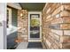 Front entrance with stonework, glass door, and a small porch at 13942 Jackson St, Thornton, CO 80602