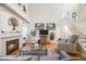 Living room with fireplace, hardwood floors, and comfortable seating at 13942 Jackson St, Thornton, CO 80602