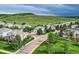 Aerial view of a neighborhood featuring well-maintained lawns and landscaping against a mountain backdrop at 7866 Witney Pl, Lone Tree, CO 80124
