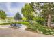 Enjoy the outdoors in this landscaped backyard with a white fence and comfortable lounge chairs at 7866 Witney Pl, Lone Tree, CO 80124